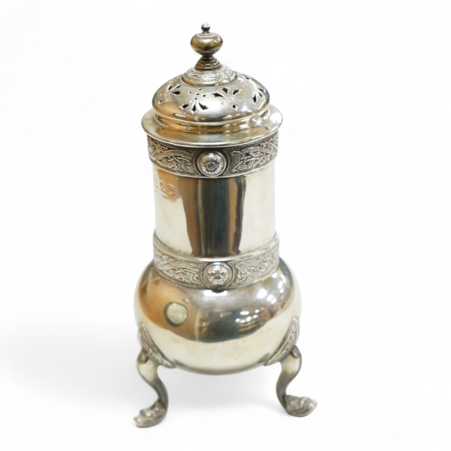 A George V Irish silver sugar caster, by West & Son, Dublin, 1914, decorated with Celtic bands, height 16.7cm, 9.9oz.